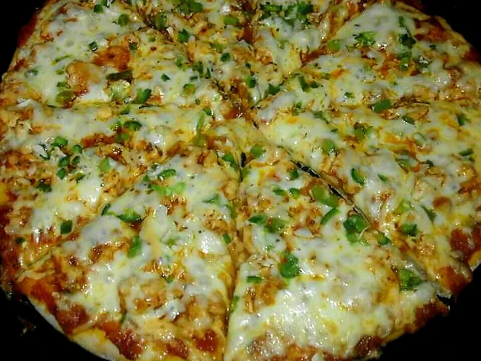 Mr Bake signature pizza with melted cheese and herbs
